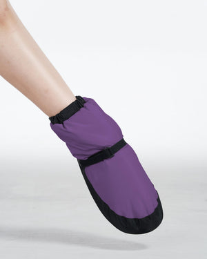 Purple warm up bootie on pointed foot, side view
