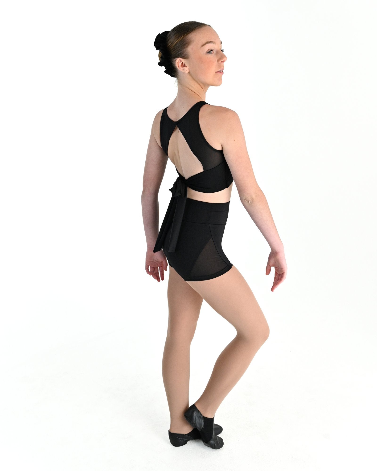 Young dancer wearing the Aura tie back dance crop top in Black, alternate view