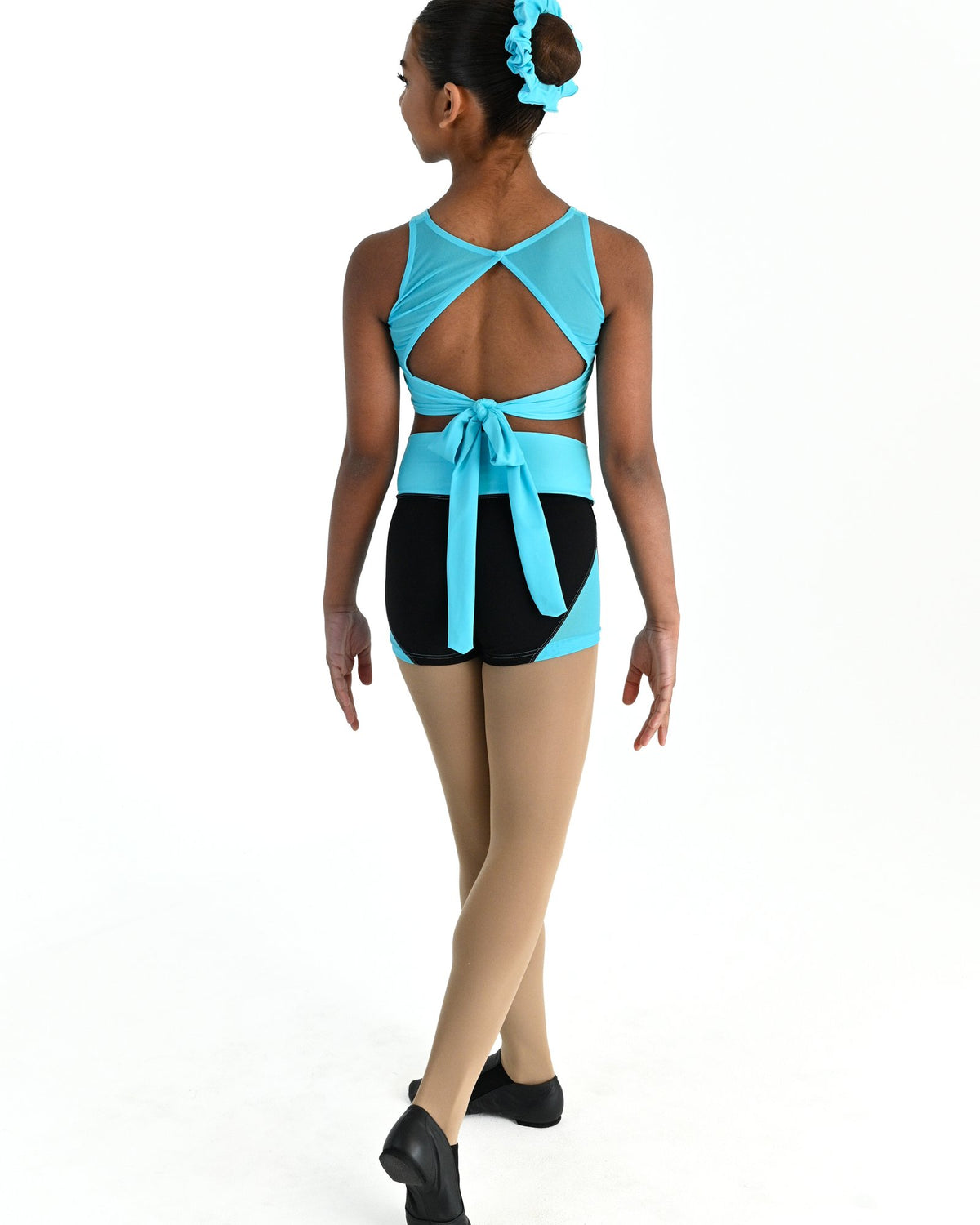 Young dancer wearing the Aura tie back dance crop top in Lagoon, alternate view