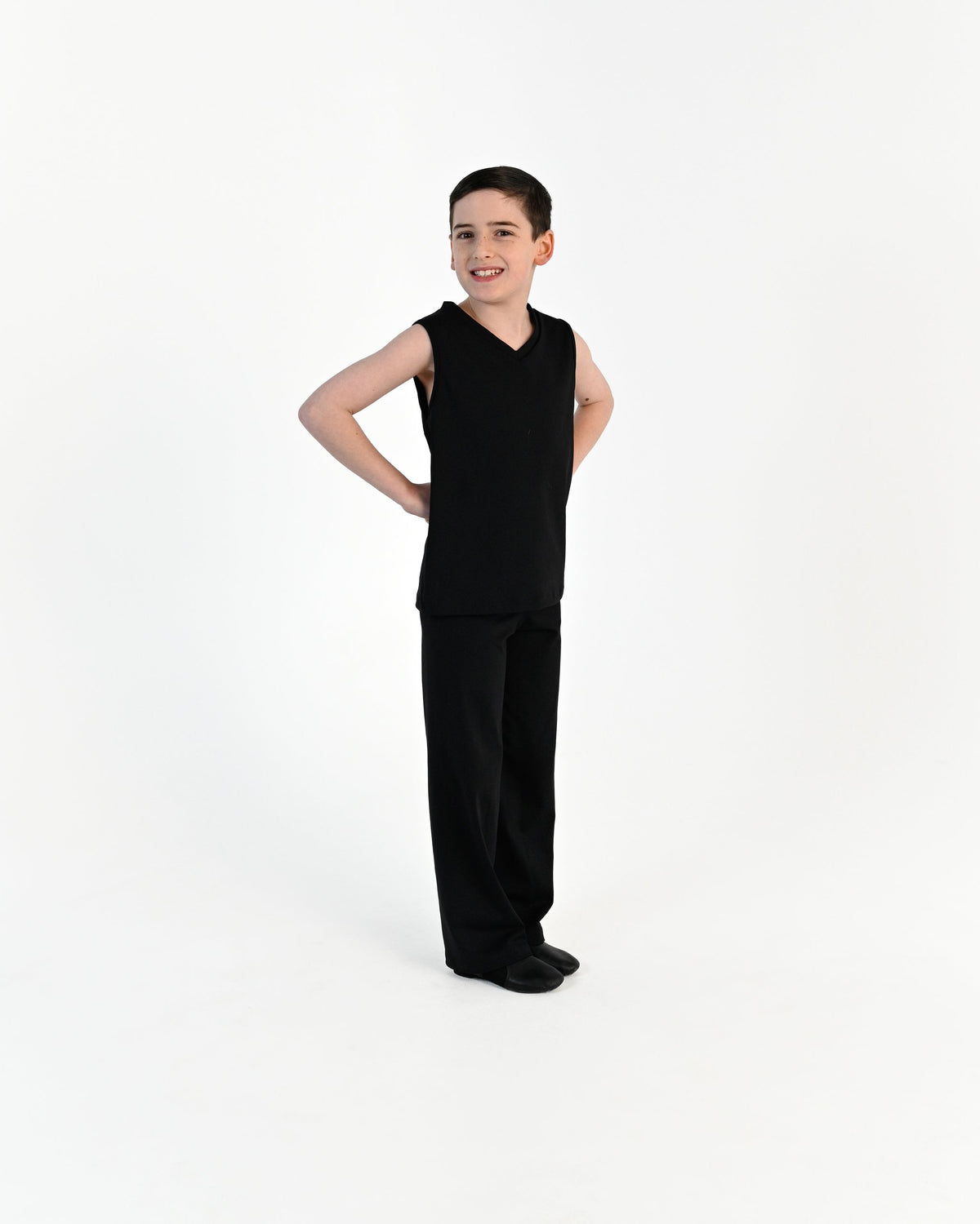 Young dancer wearing the Essential Boys Straight Leg Dance Pant in Black, alternate view