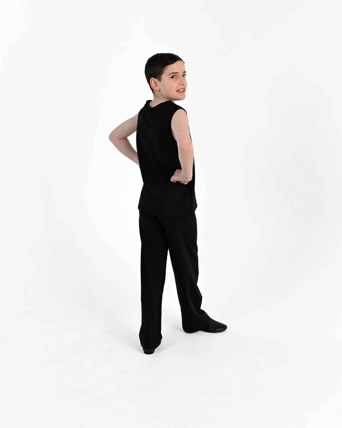 Young dancer wearing the Essential Boys Straight Leg Dance Pant in Black, alternate view