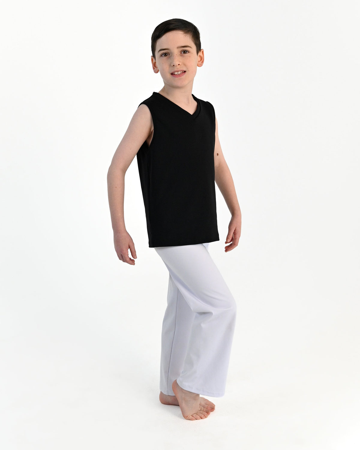 Young dancer wearing the Essential Boys Straight Leg Dance Pant in White, alternate view