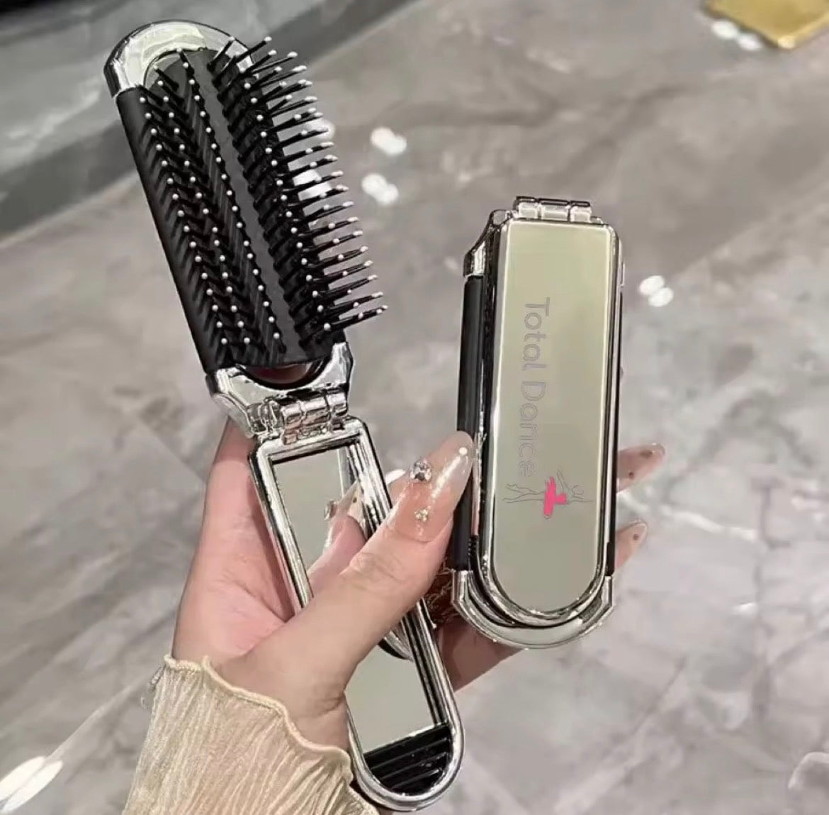 Total Dance foldable hair brush with removable mirror, metallic silver finish, palm-sized dance bag essential
