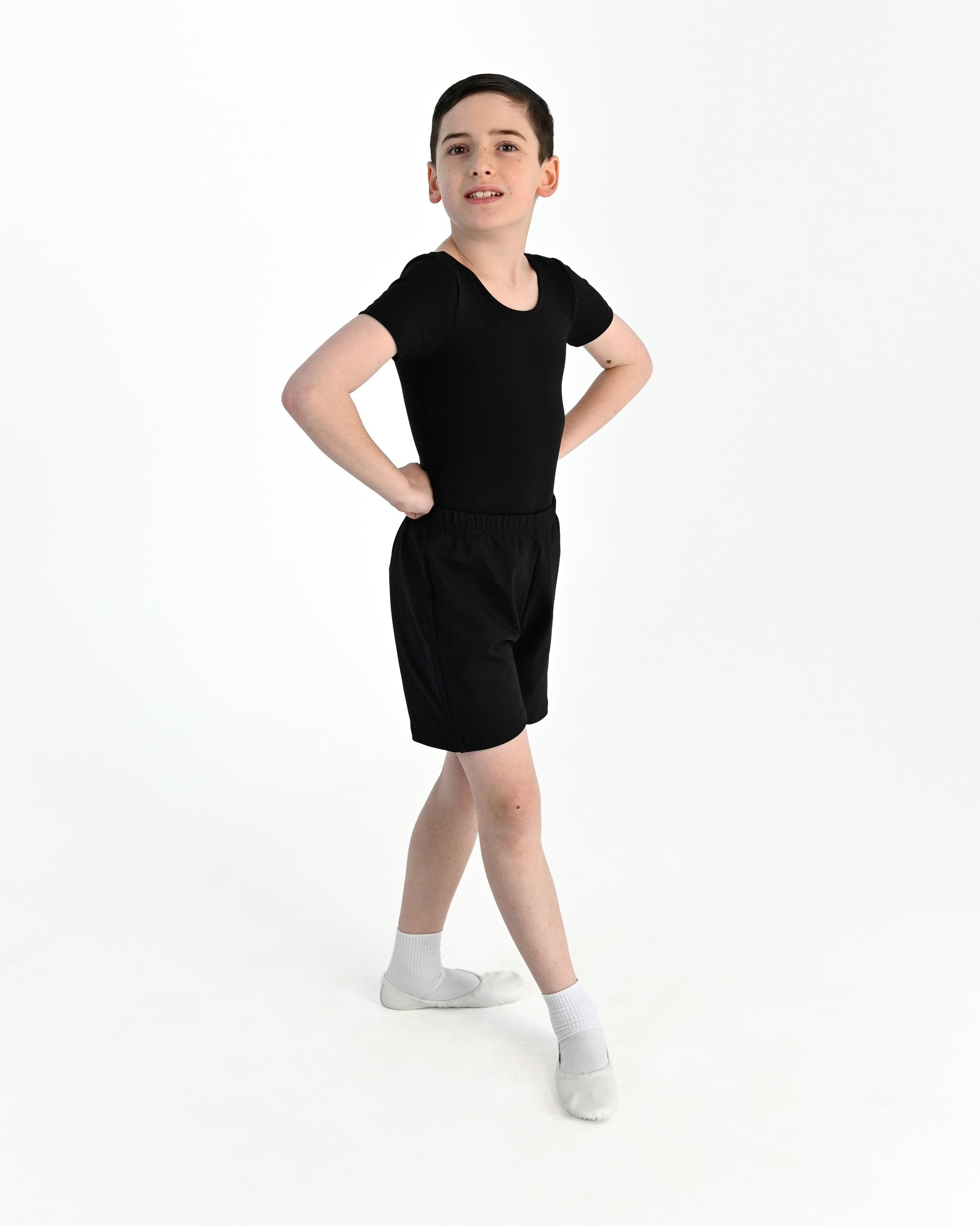 Young dancer wearing the Essential Boys Short Sleeve Leotard in Black