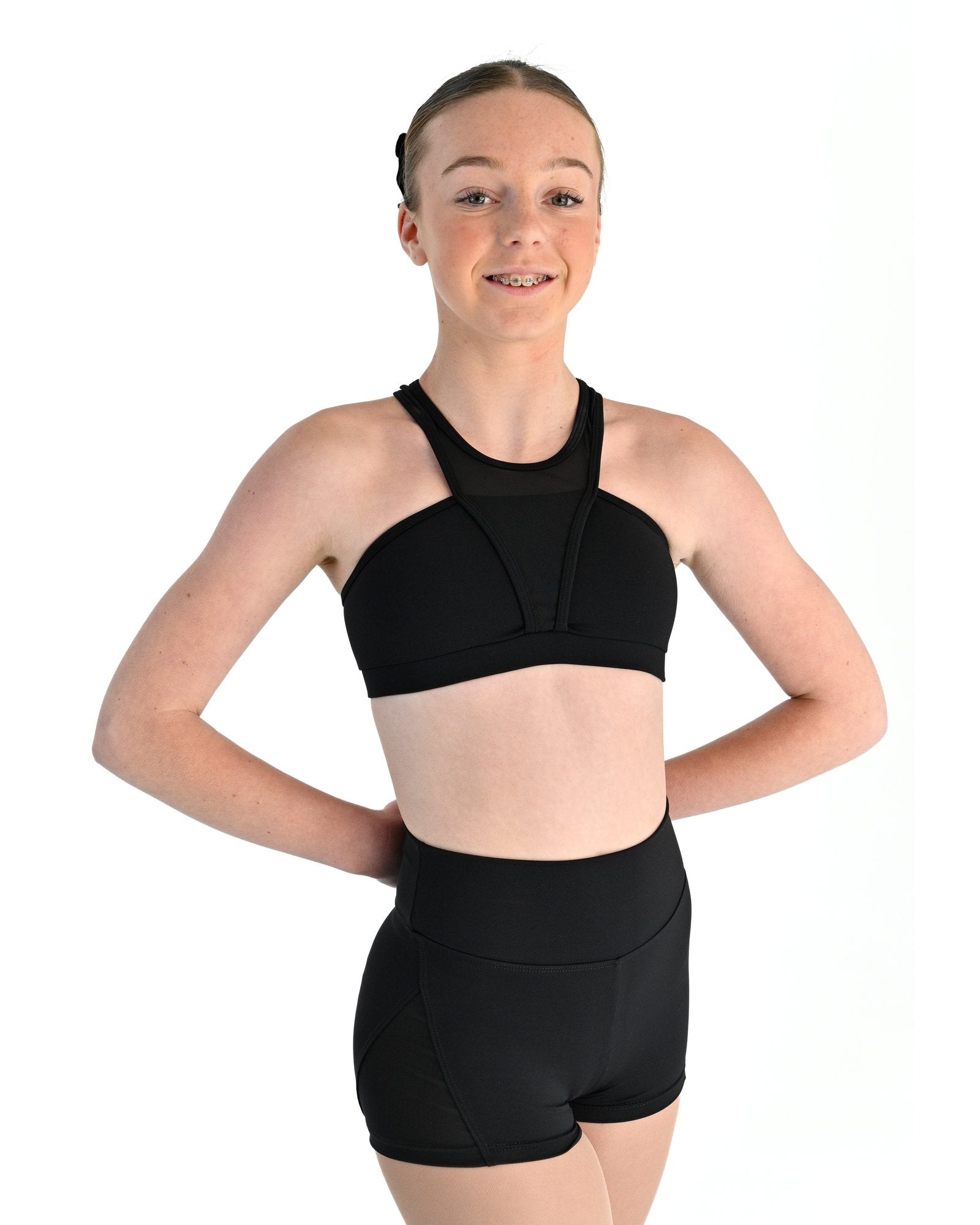 Young dancer wearing the Electra crossover racerback dance crop top in Black