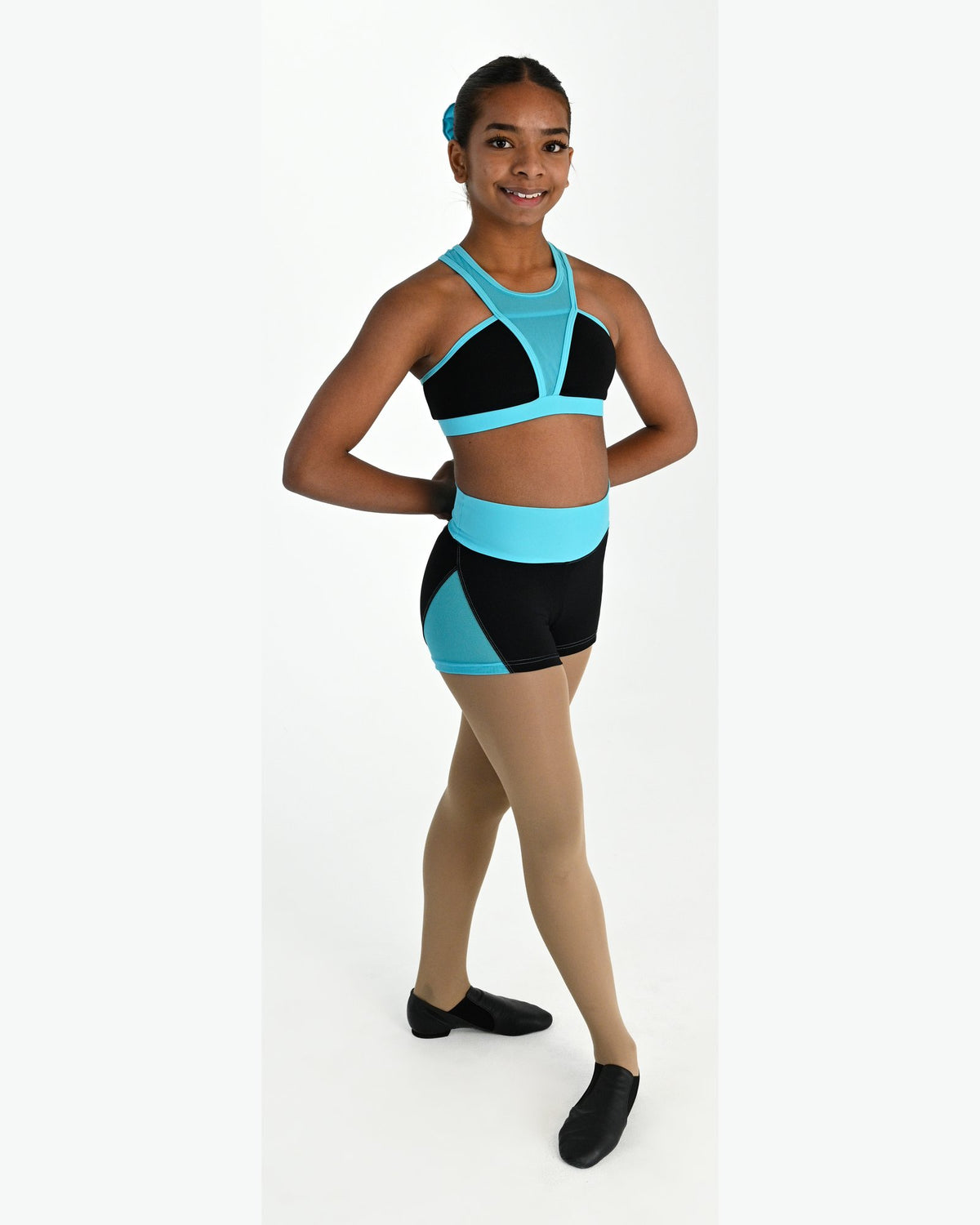Young dancer wearing the Electra crossover racerback dance crop top in Lagoon