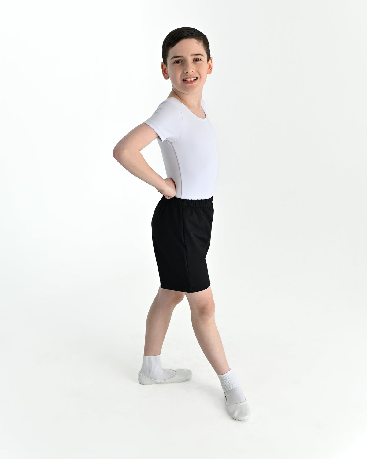Young dancer wearing the Essential Boys Basic Dance Shorts in Black
