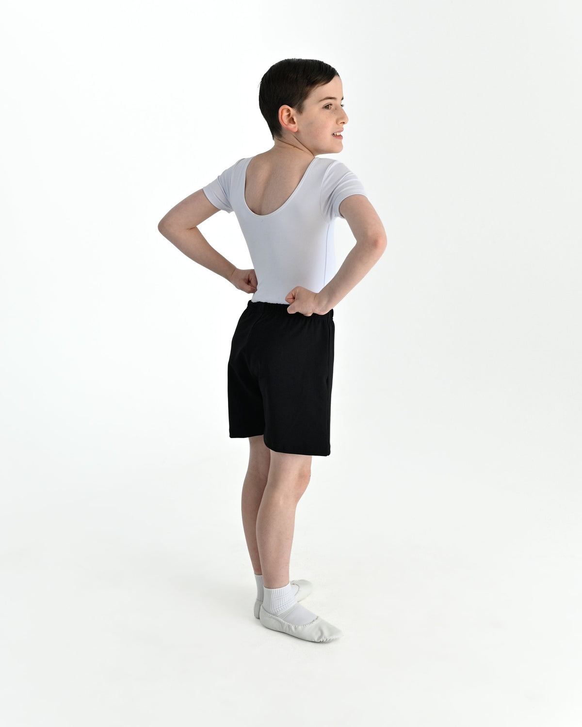Young dancer wearing the Essential Boys Basic Dance Shorts in Black, alternate view