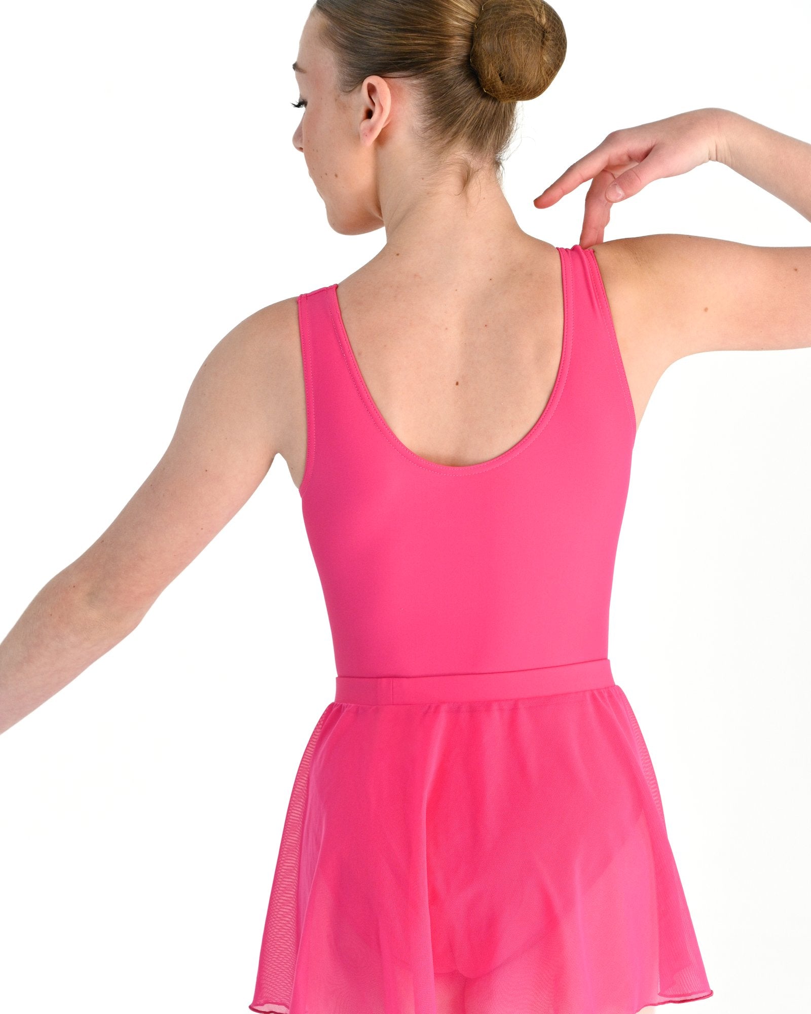 Young dancer wearing the Mesh Pull-On Ballet Wrap Skirt in Hot Pink, alternate view