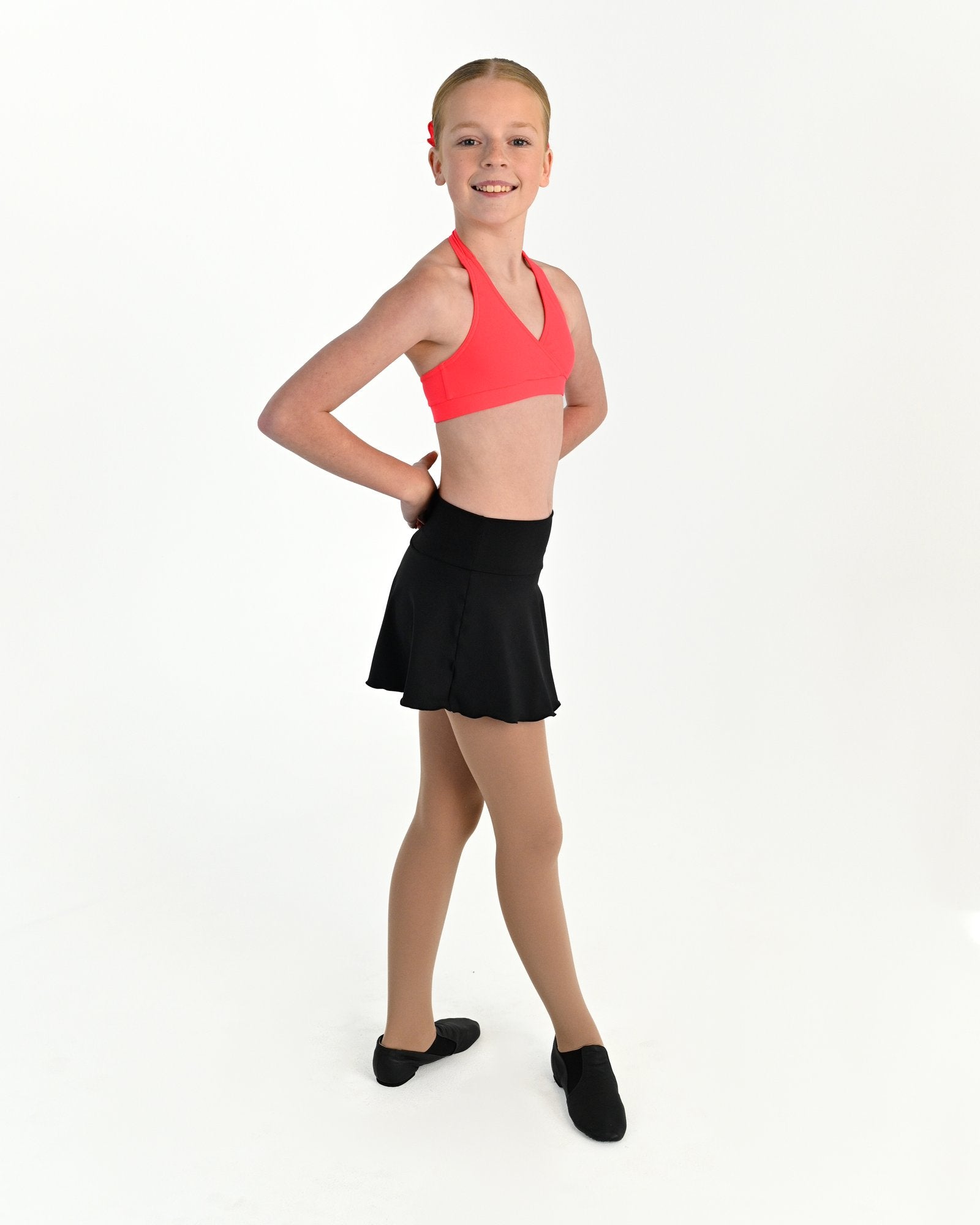 Young dancer wearing the Mila dance skort with fitted shorts underneath in Black