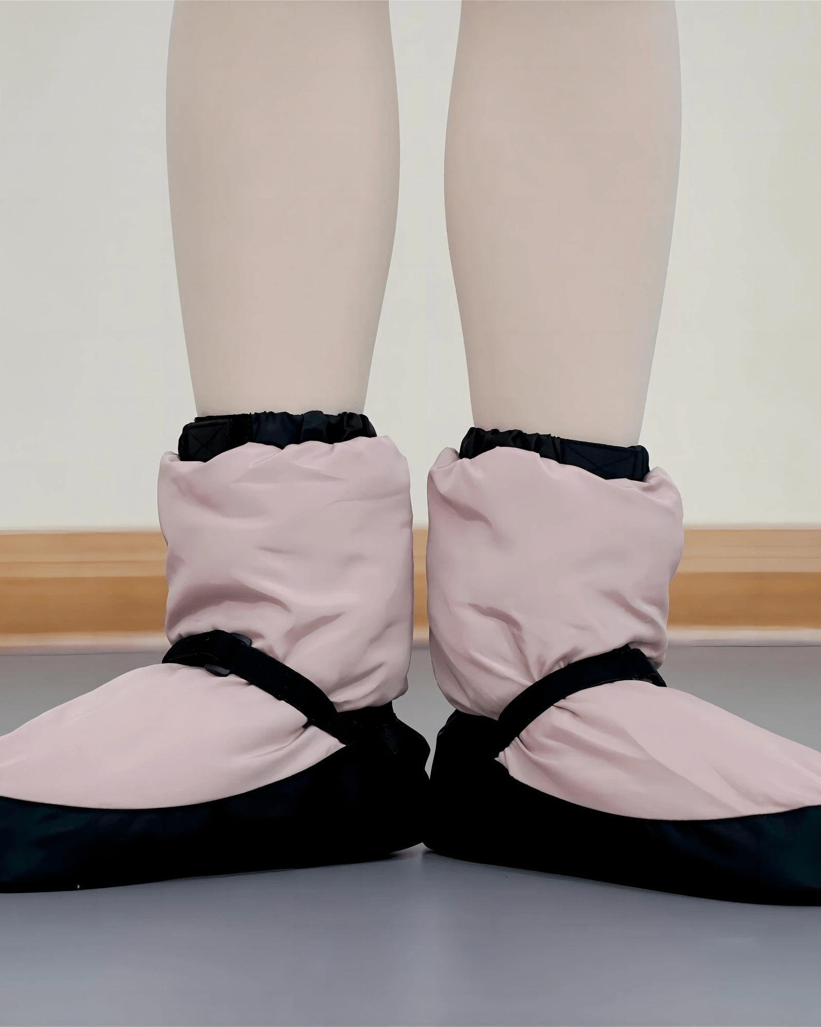 Dusk pink warm up dance booties, front view in dance studio